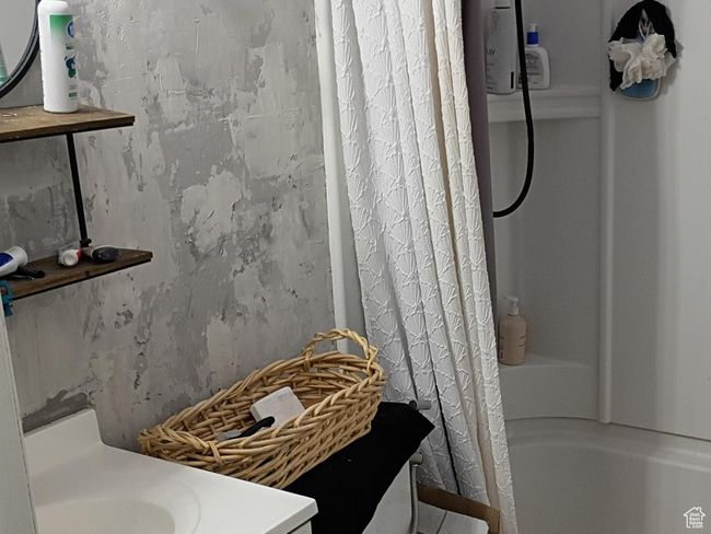 Full bath featuring tile patterned flooring, vanity, and shower / tub combo with curtain | Image 15