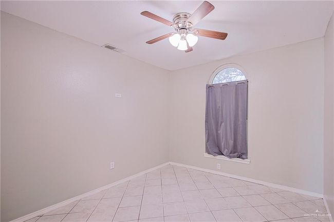 Spare room with light tile patterned floors, ceiling fan, visible vents, and baseboards | Image 20