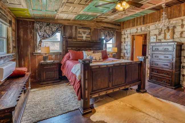 Bedroom with wood walls, an ornate ceiling, and hardwood / wood-style floors | Image 7