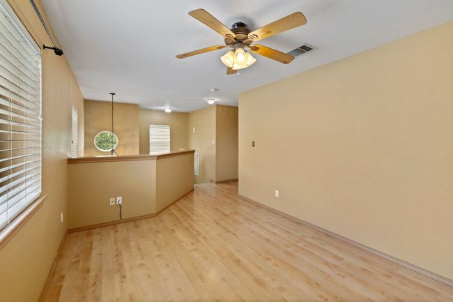 Empty room with light wood-type flooring and ceiling fan | Image 19