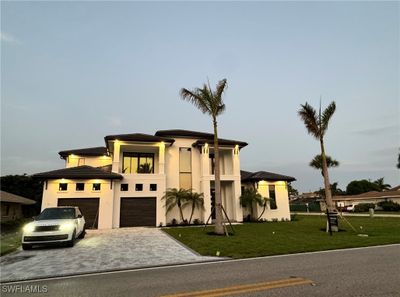 View of front facade featuring a garage and a front lawn | Image 1