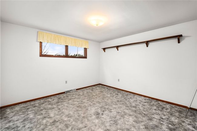 THE SECOND BEDROOM ALSO HAS HARDWOOD FLOORING UNDER THE CARPET. | Image 17