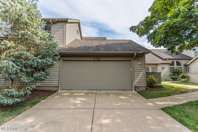 View of front facade featuring roof with shingles, an attached garage, and concrete driveway | Image 4