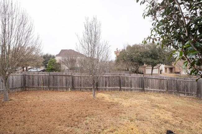 View of fenced backyard | Image 26