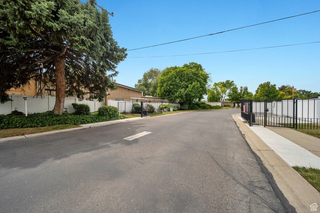 View of asphalt with curbs, a gate, and sidewalks | Image 20