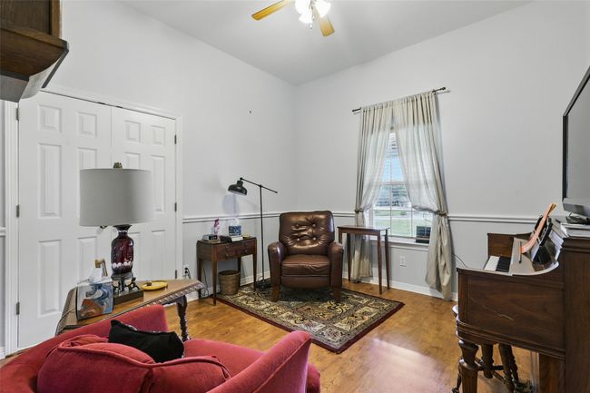 Living area with ceiling fan and wood finished floors | Image 10