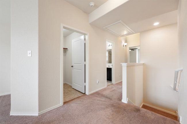 Hallway with attic access, carpet flooring, an upstairs landing, and baseboards | Image 21