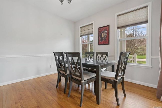 Dining area featuring wood finished floors and baseboards | Image 5