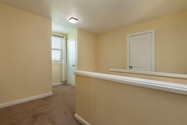 Hallway with light carpet and baseboards | Image 20