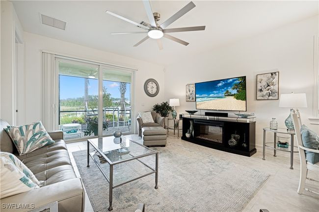 Living area featuring ceiling fan and tile patterned flooring | Image 7