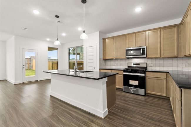 Natural light pours in through large windows, creating a bright and airy atmosphere that makes cooking feel less like a chore and more like a delightful experience. | Image 4