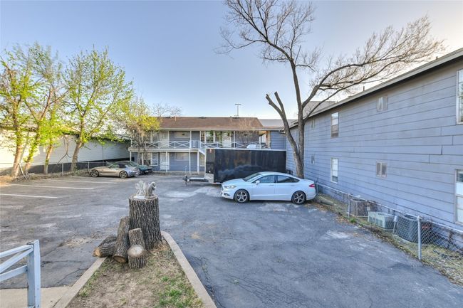 Uncovered parking lot with fence | Image 12