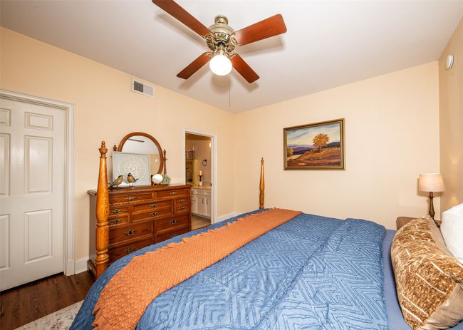 Bedroom featuring wood finished floors and ceiling fan | Image 17