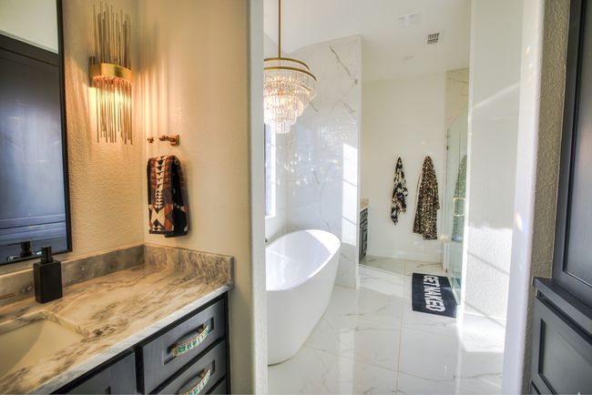 Bathroom featuring vanity, visible vents, a freestanding tub, marble finish floor, and a chandelier | Image 17