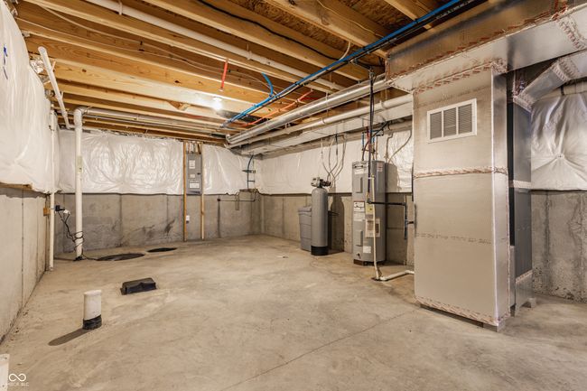 unfinished basement with water heater, heating unit, and visible vents | Image 40