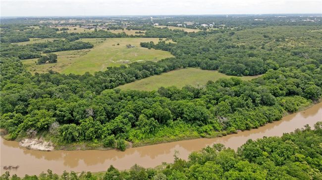 Aerial view of a large body of water and a forest | Image 8