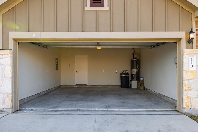 Garage with gas water heater and water softener | Image 9