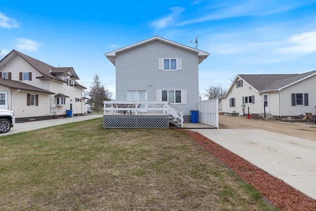 Large back deck that leads into the dining/kitchen of the home. | Image 6