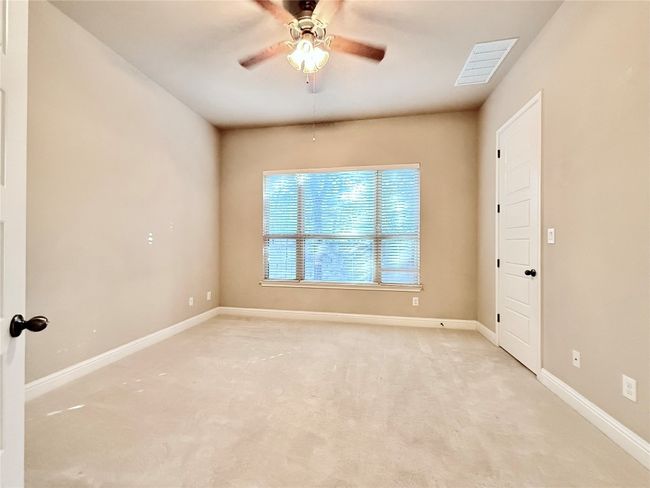 Spare room featuring light colored carpet and ceiling fan | Image 29