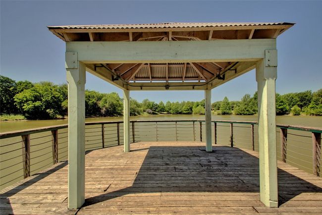 Wooden terrace featuring a water view and a gazebo | Image 29
