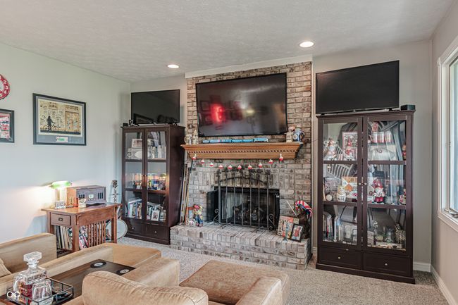 living area with recessed lighting, carpet floors, baseboards, a fireplace, and a textured ceiling | Image 39