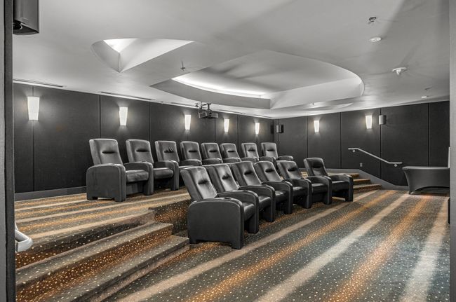 Carpeted home theater room featuring a raised ceiling and a decorative wall | Image 17