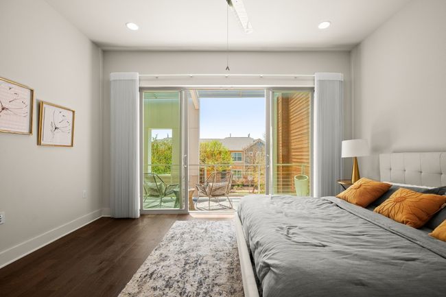 Bedroom with access to outside, dark wood finished floors, baseboards, and recessed lighting | Image 13