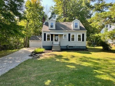 Cape cod-style house with a front lawn | Image 1