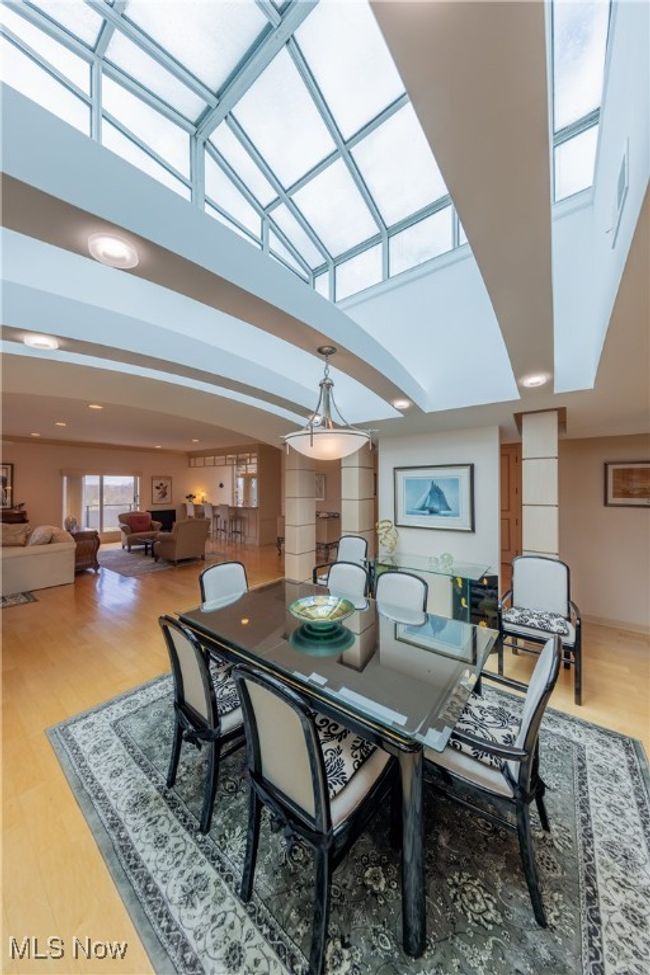 Dining room with skylights, arched ceiling, and light wood flooring | Image 5
