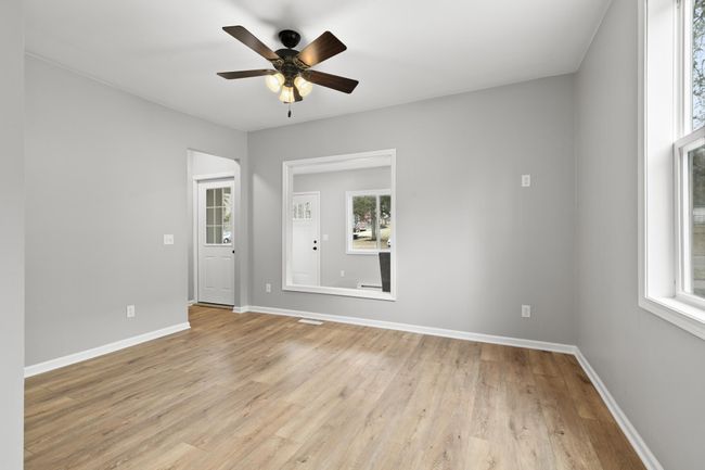 Another view of the living room with ceiling fan. | Image 9