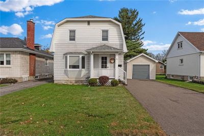 Pretty on Peter! This home offers nice curb appeal, single garage and extra wide paved drive. | Image 1