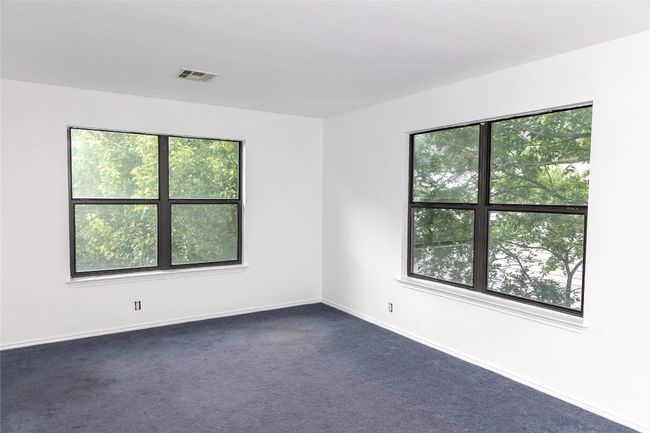 Spare room featuring dark carpet and baseboards | Image 7