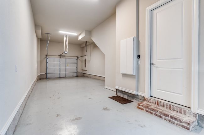 Garage with baseboards and a garage door opener | Image 32