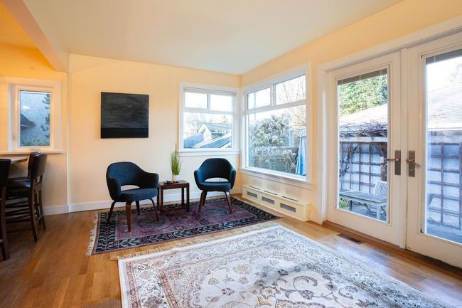 Sitting room with visible vents, wood finished floors, and a healthy amount of sunlight | Image 11