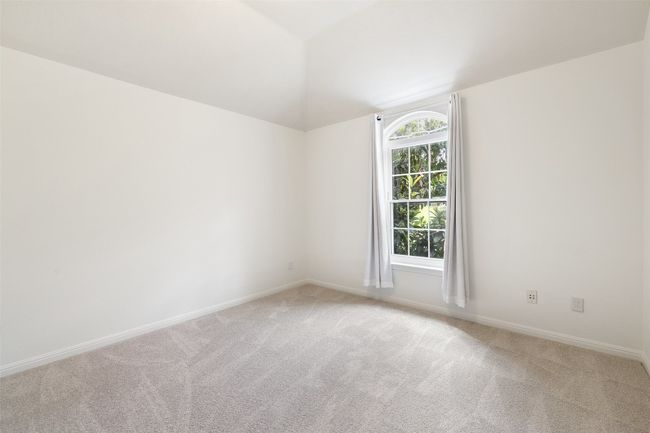 Empty room with light carpet and vaulted ceiling | Image 31