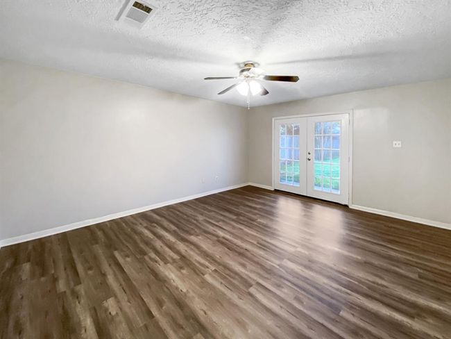 The master bedroom features a private covered patio that overlooks the backyard. | Image 11