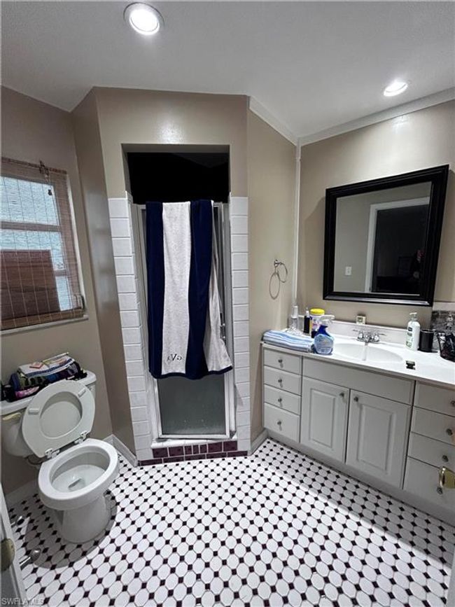 Bathroom featuring a shower, vanity, and toilet | Image 12
