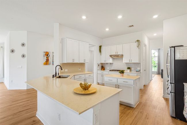 SPECTACULAR KITCHEN WITH BAR-TOP SEATING, QUARTZ COUNTERS, STAINLESS APPLIANCES & CABINETS GALORE !!! | Image 14