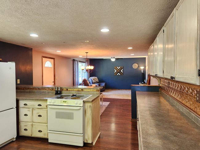 The very well laid out kitchen boasts lots of counter space and visibility to dining & living areas. | Image 8
