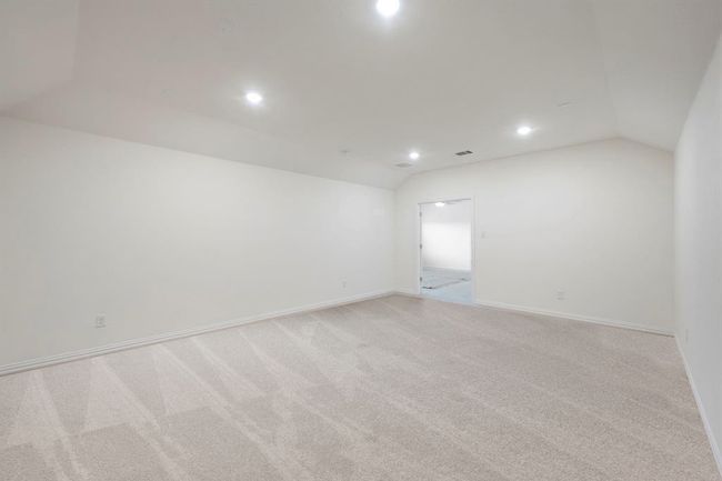 Empty room featuring vaulted ceiling, recessed lighting, light colored carpet, and baseboards | Image 28