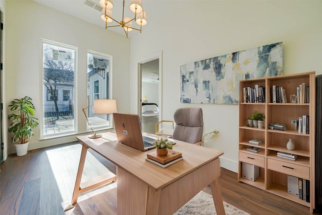 Office area featuring plenty of natural light, hardwood / wood-style floors, and a notable chandelier | Image 14