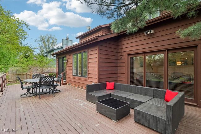 Wooden deck featuring fence, an outdoor hangout area, and outdoor dining area | Image 34