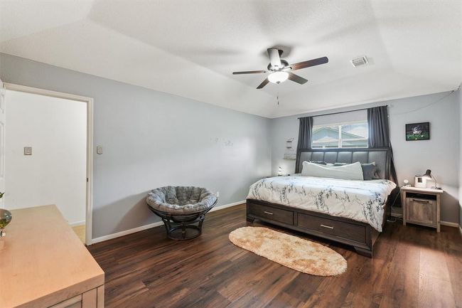 Primary bedroom with laminate wood plank flooring | Image 17