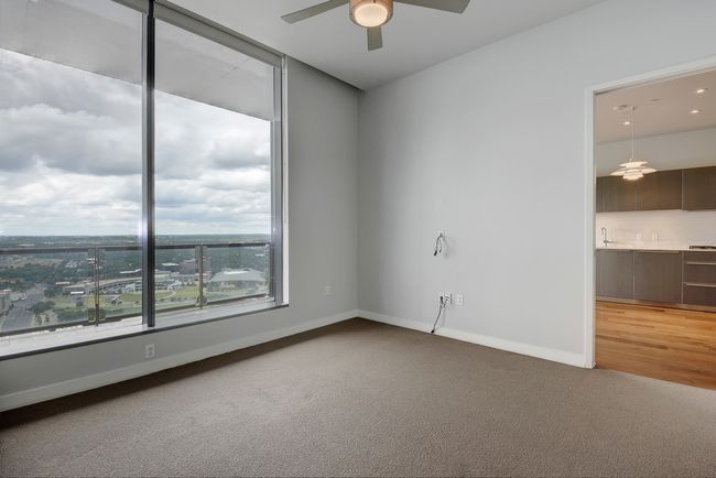 Spare room with ceiling fan, light colored carpet, baseboards, and a sink | Image 10