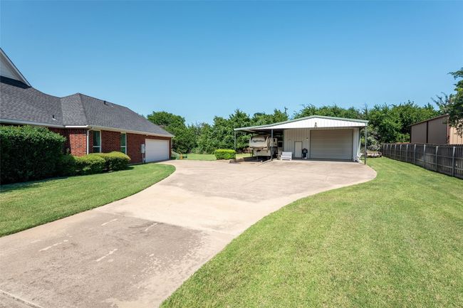 View of yard with a garage and driveway | Image 6
