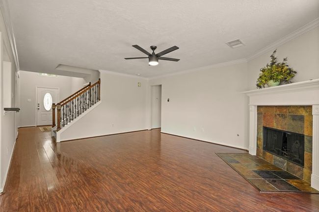 Spacious living room with seamless kitchen view. | Image 9