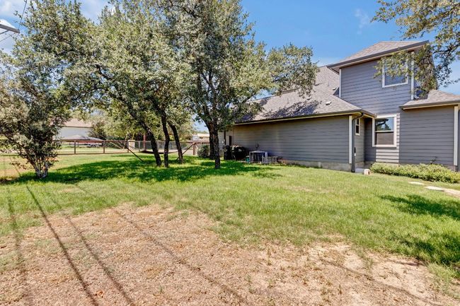 View of fenced backyard | Image 25