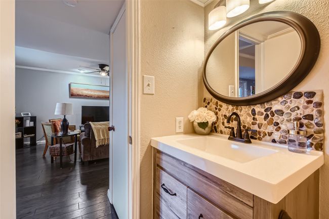 Bathroom with a textured wall, vanity, hardwood / wood-style flooring, a ceiling fan, and crown molding | Image 12