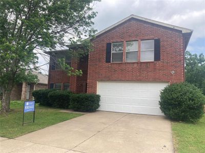 Front facade with a garage and a front lawn | Image 1