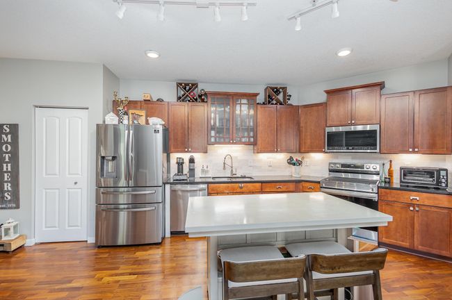 Pantry and abundant cabinetry in the open kitchen. | Image 4